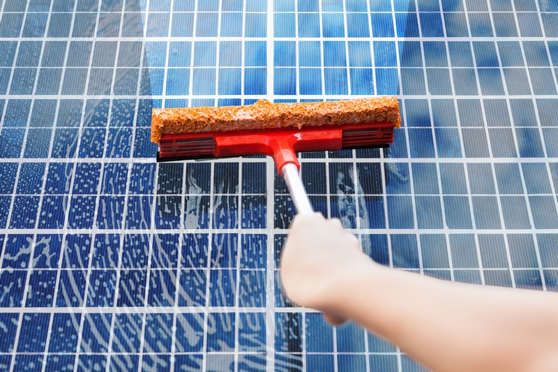 Close-up,Of,Person,Hand,Cleaning,Solar,Panel.,Sustainable,Energy,Concept